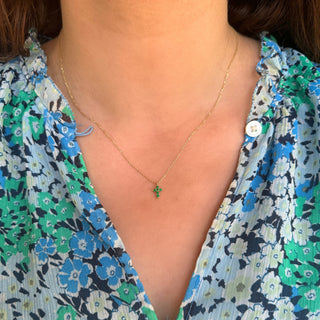 Necklace with a green pendant worn by a person in a floral dress   Lindsey Leigh Jewelry, Houston, TX
