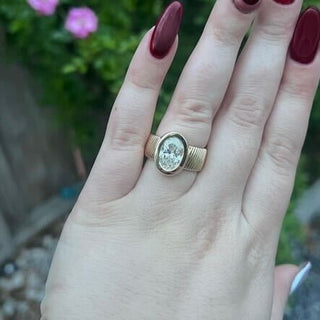 Bezel Set Oval Cut Solitaire on Detailed Gold Band  Lindsey Leigh Jewelry.
