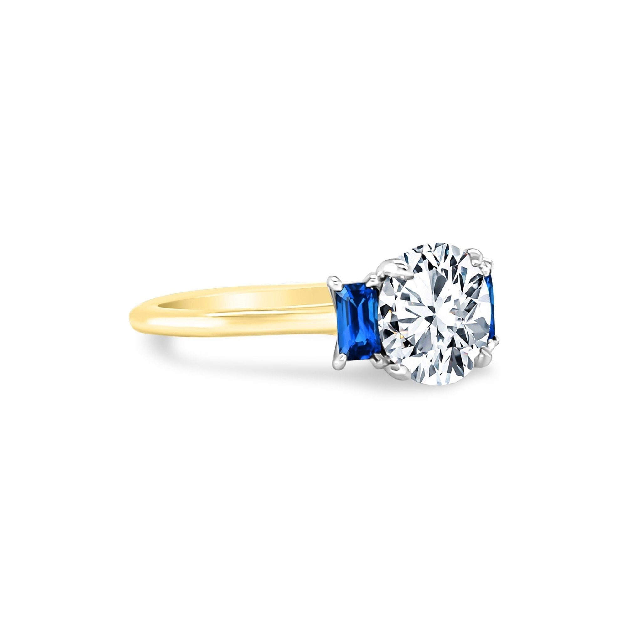 Diamond solitaire with sapphire side clearance stones